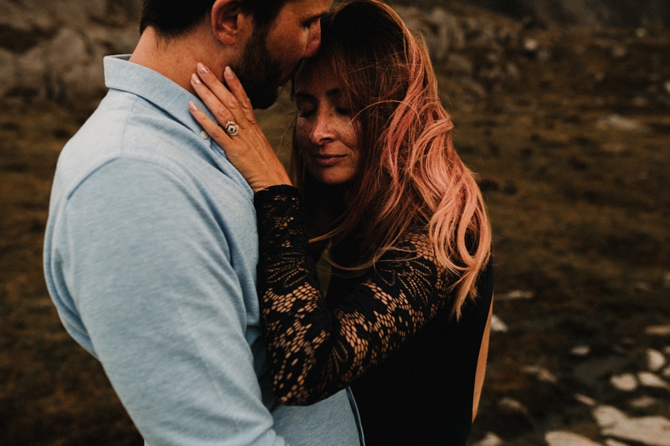 husband and wife to bee having an intimate embrace in mountains