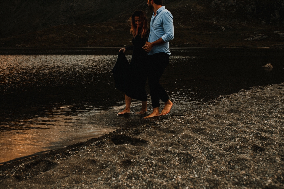 cwm ideal pre wedding shoot in mountains , couple walking in the icy lake