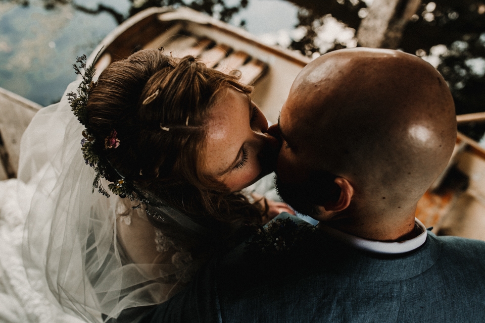 couple kissing in the boat at buckland house wedding venue