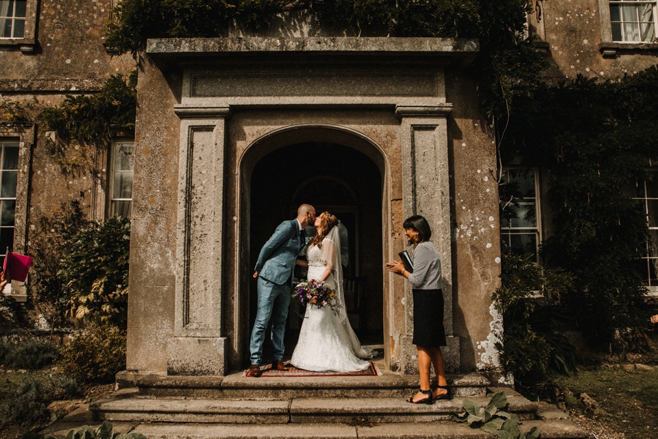 bride and grooms first kiss buckland house