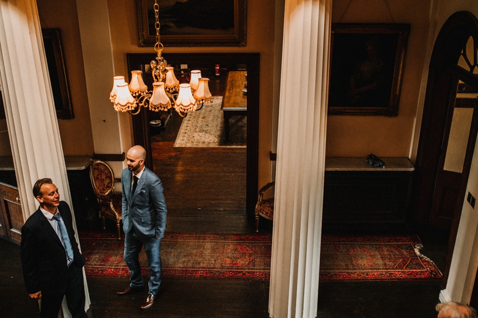 groom greeting guests to the ceremony