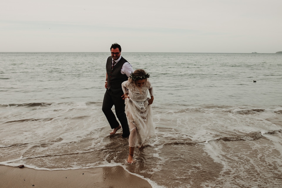 bride and groom playing carbis bay beach on wedding day 