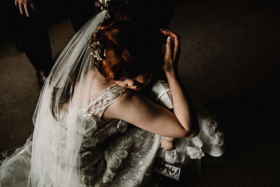 bride and flower girl having a cuddle at Hever castle