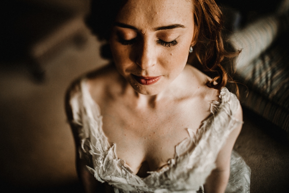 bride getting into her wedding gown 