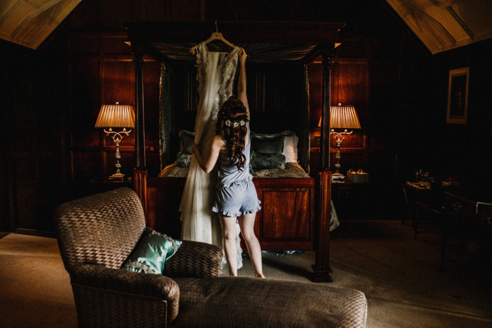 bride getting into her wedding gown 