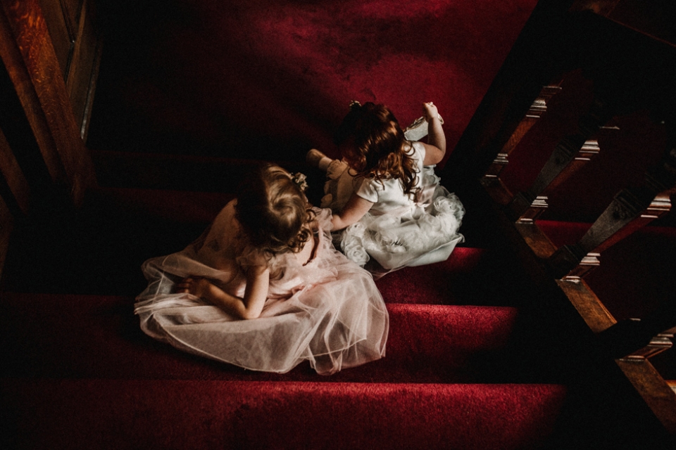 two little flower girls playing on the steps at Hever Castle