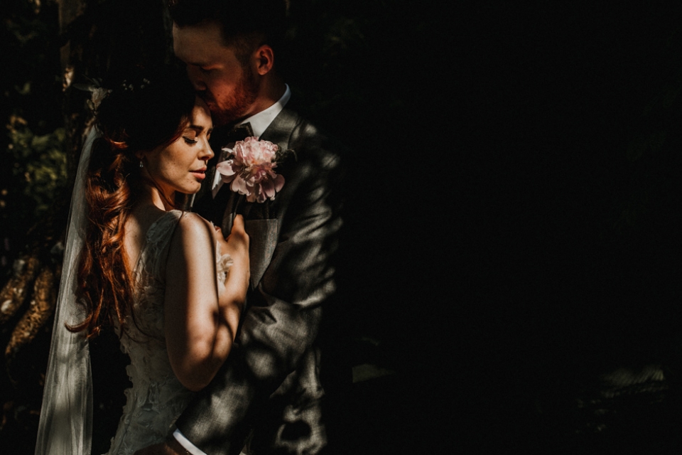 couple portraits in dappled light , italian gardens , never castle