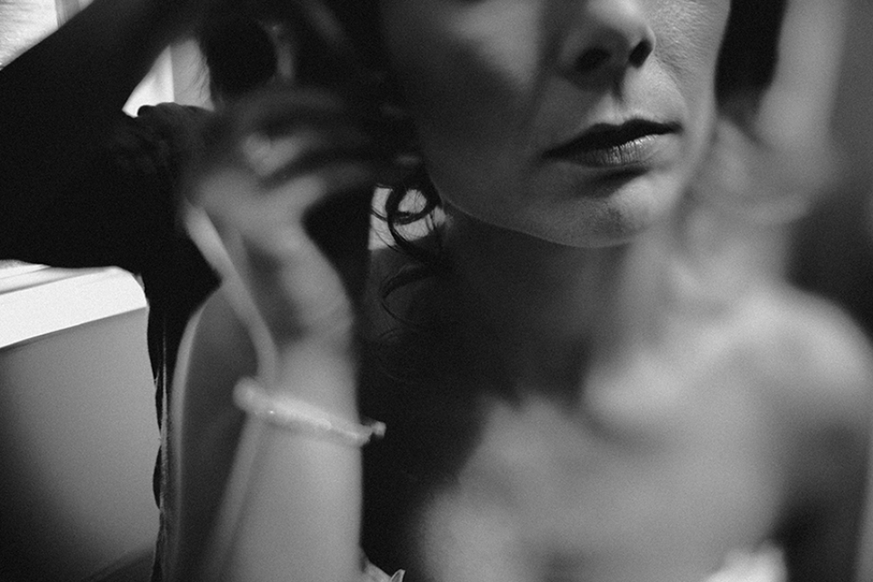 bride putting in her earring in the bridal prep