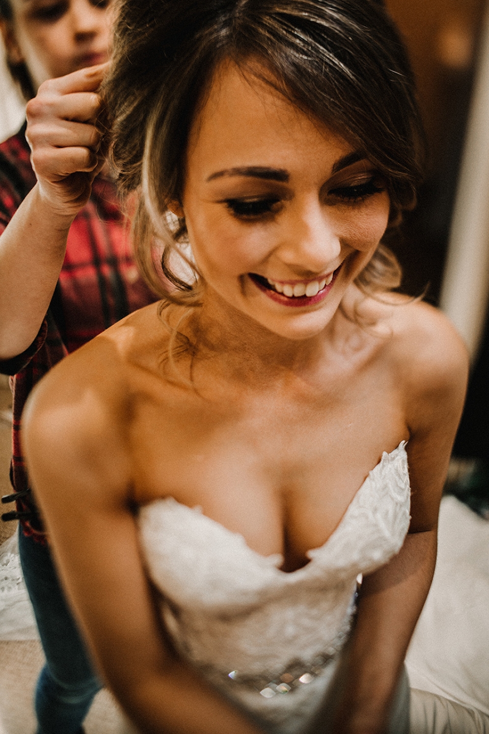 bride getting into her dress at bridal prep