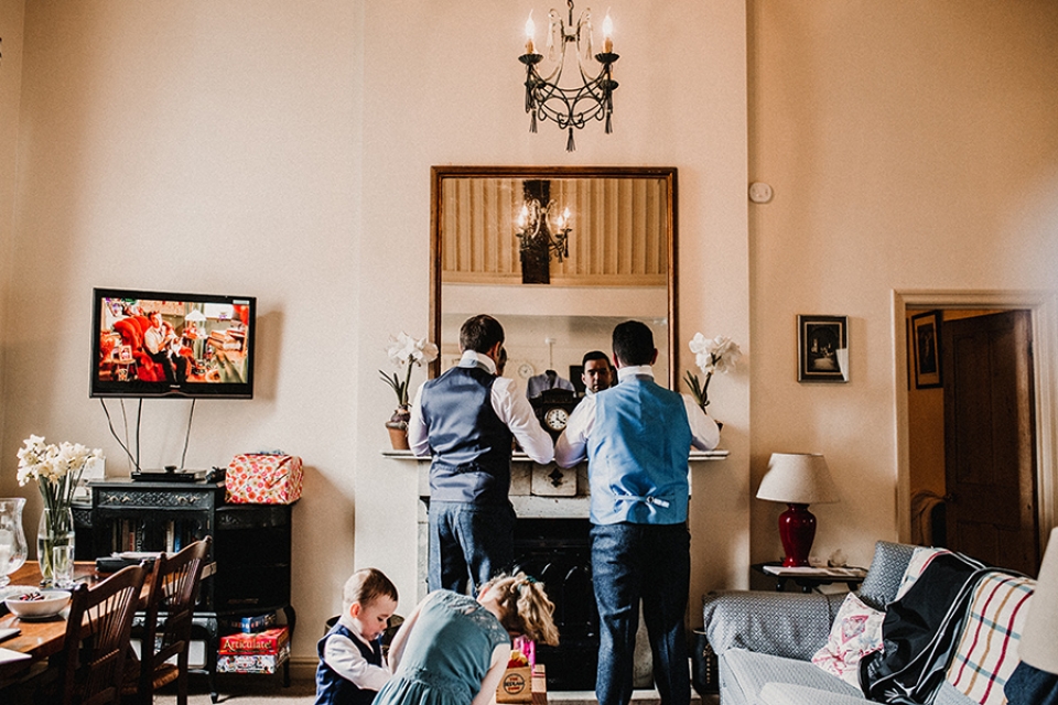 usher and groom getting ready while children play