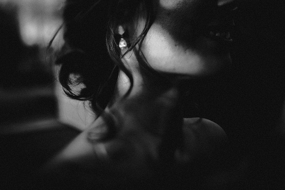 close up and freelanced earring worn by bride , black and white edit 