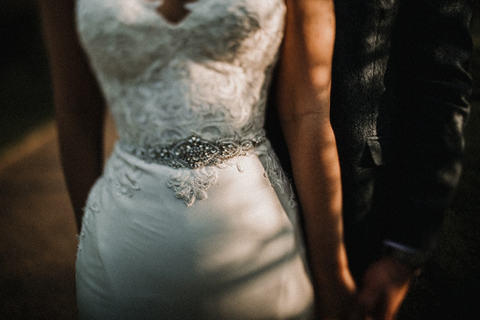 bride and groom holding hands at comberemere walled gardens