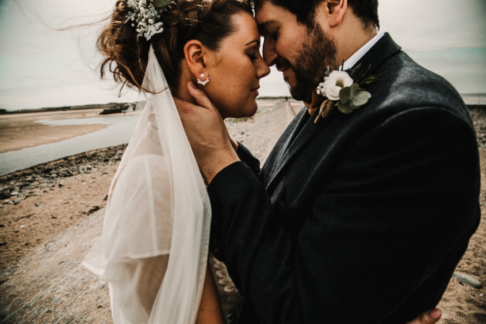 Bride and groom enjoying a cuddle on their wedding day 