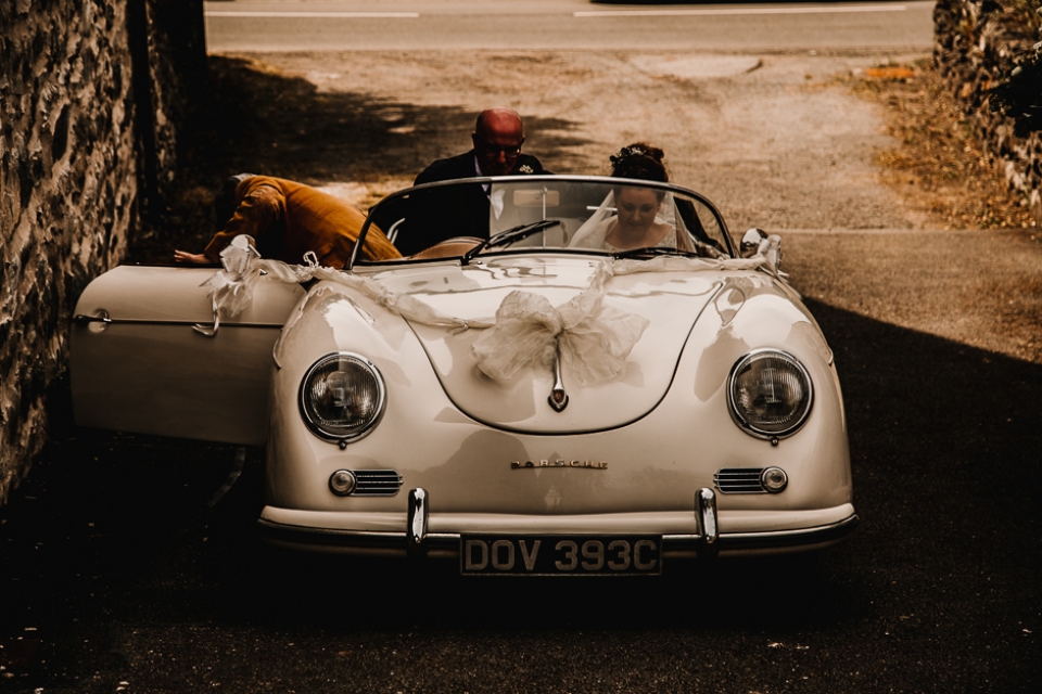 bride and father of the bride arriving in porsche at the church wedding car 