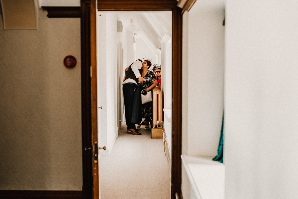 groom giving his mother a kiss on the cheek during bridal preps