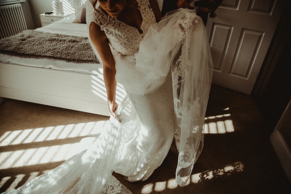 bride swishing her dress at bridal prep