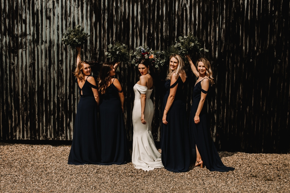 team bride and bridesmaids at the venue barns