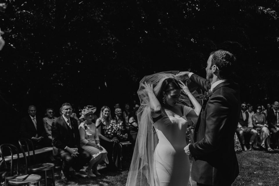 beautiful wedding ceremony in the walled gardens in cripps barn