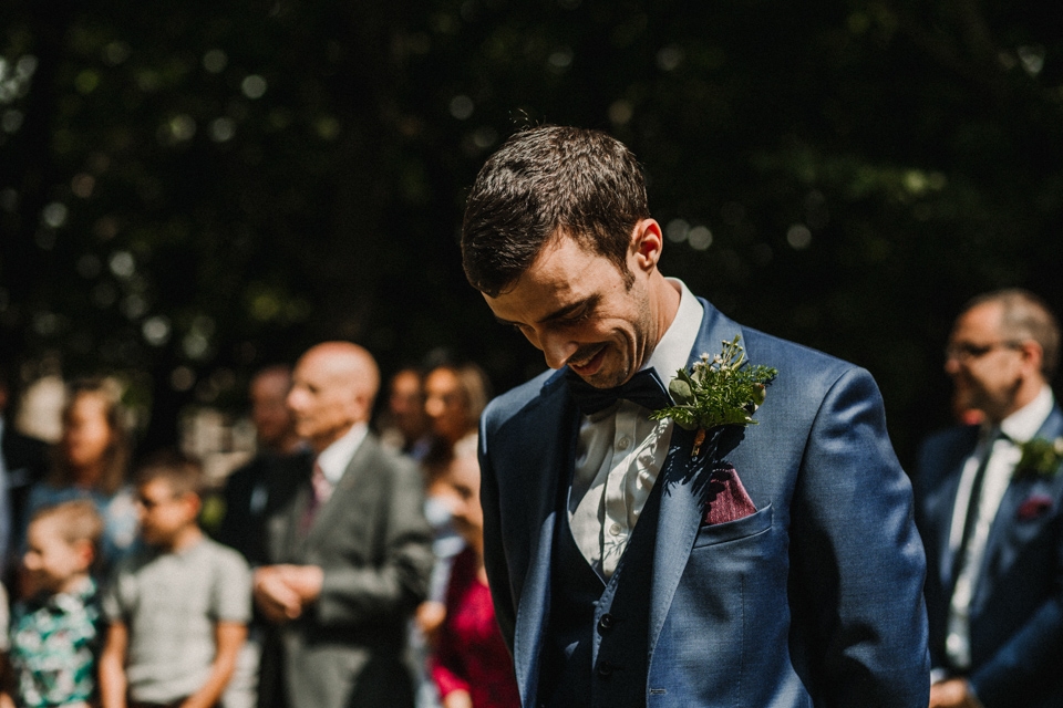 groom waiting for his wife to be walking down the aisle