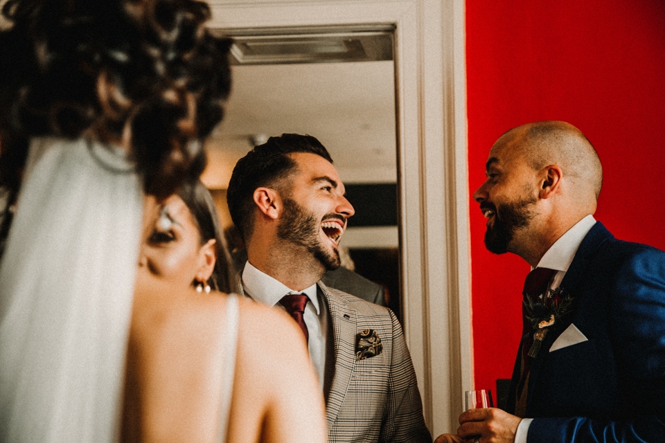 bride and groom laughing with friends at isycoed