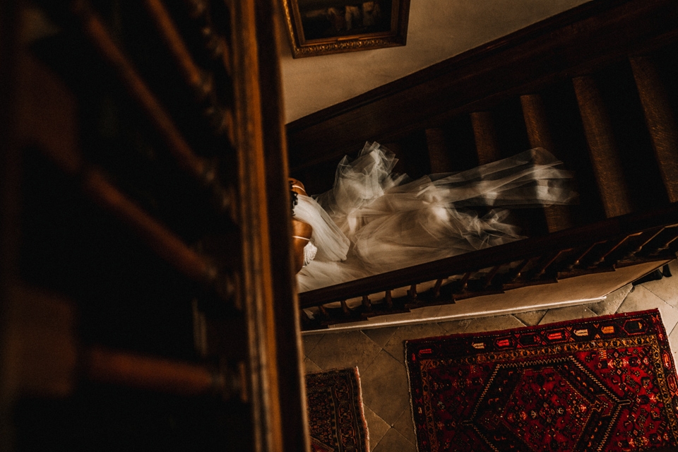 bride walking down the stairs towards the ceremony room at Isycoed