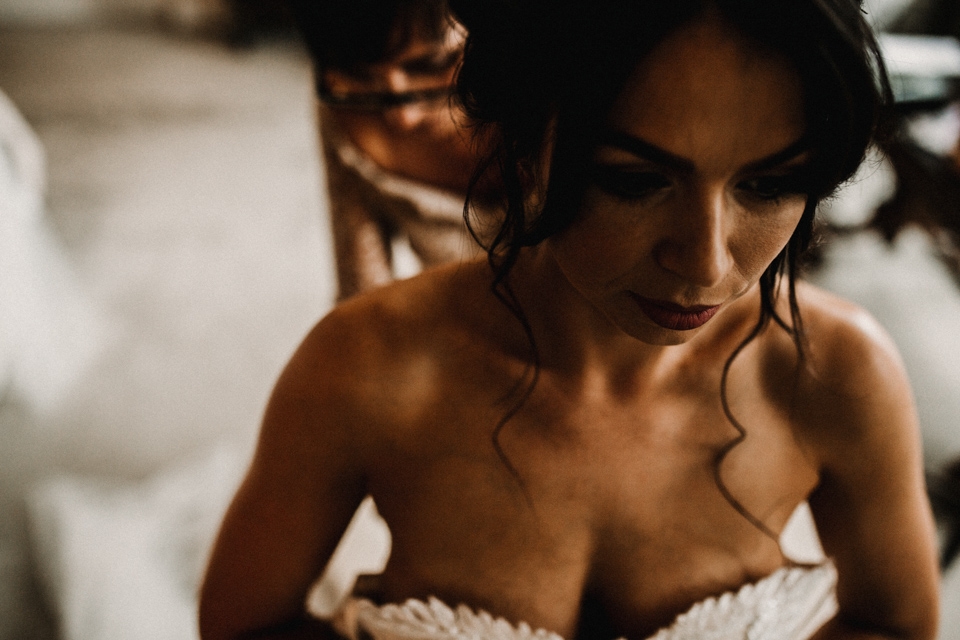 bride getting into her wedding dress