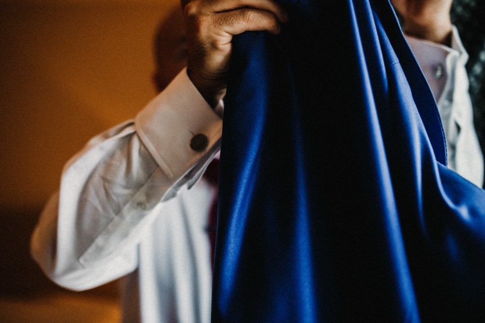 groom placing his jacket on