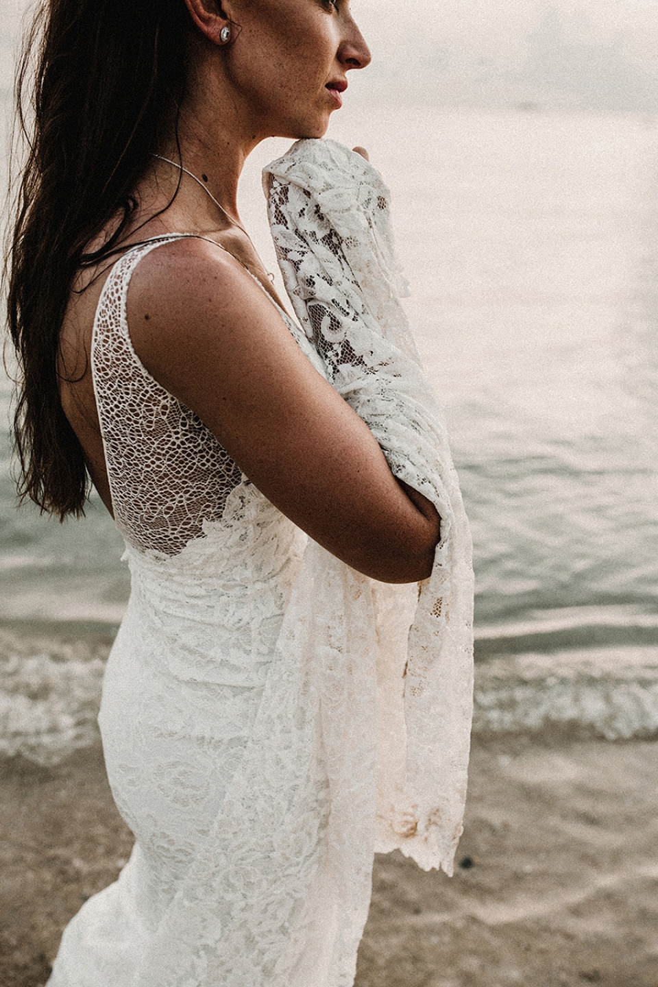 bride gazing out to see in grace loves lace dress