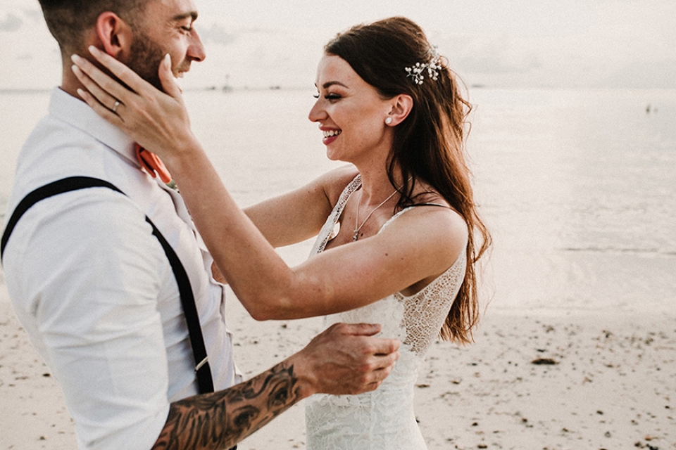 couple laughing together on the beach 