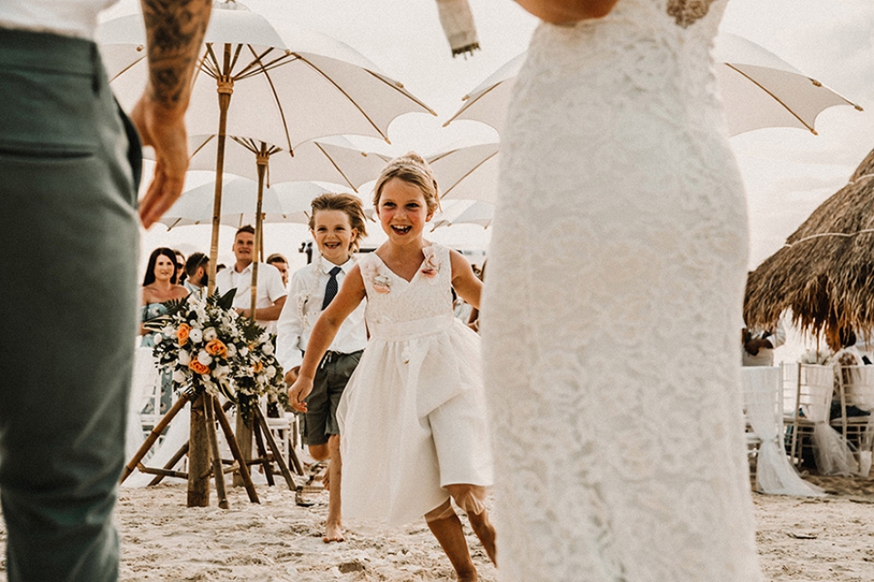 bride and groom daughter running up to congratulate them x