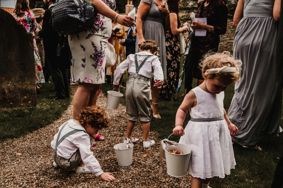 flower girls nd page boys throwing confetti