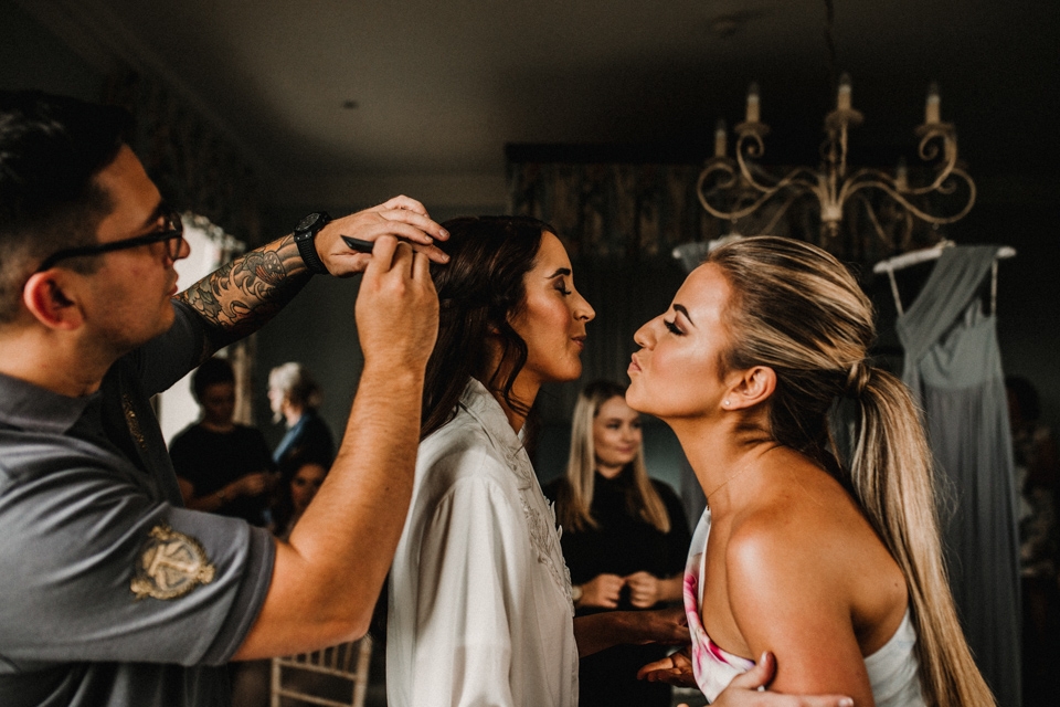 bridesmaids helping bride with her hair