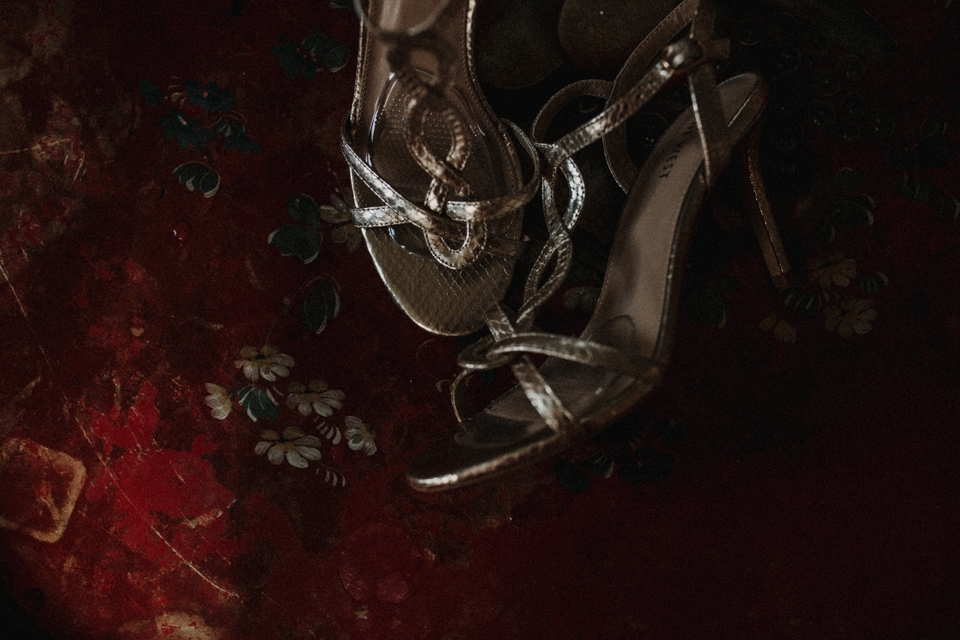 brides wedding shoes , on red table at Talbot hotel 