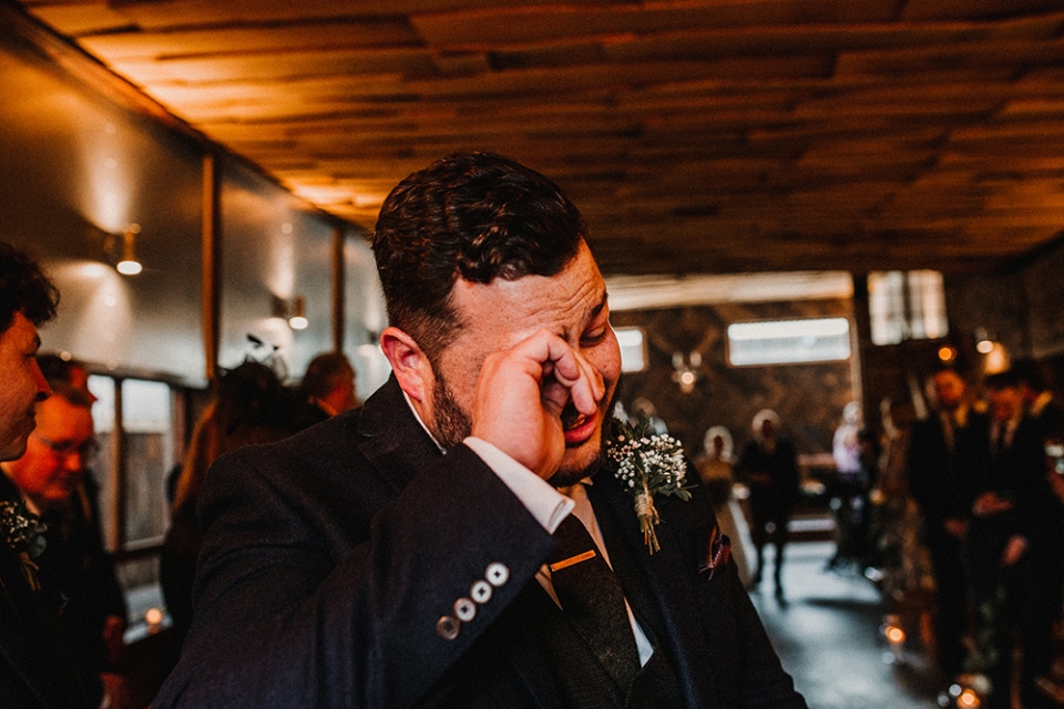 groom tearing up at the ceremony 