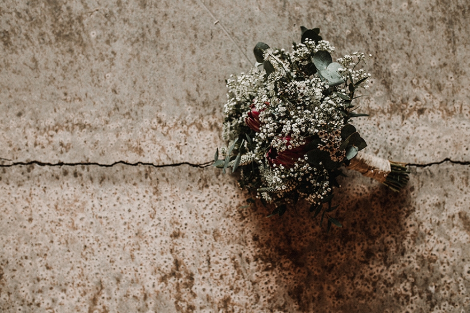 bridal bouquet laid onto industrial concrete flooring.