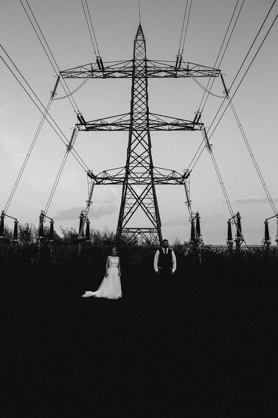 bride and groom standing apart from one another under the pilots