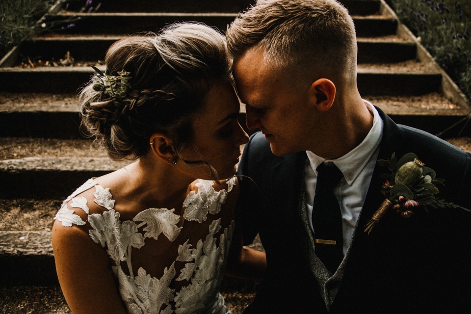 couple sitting on the steps at west mill kissing