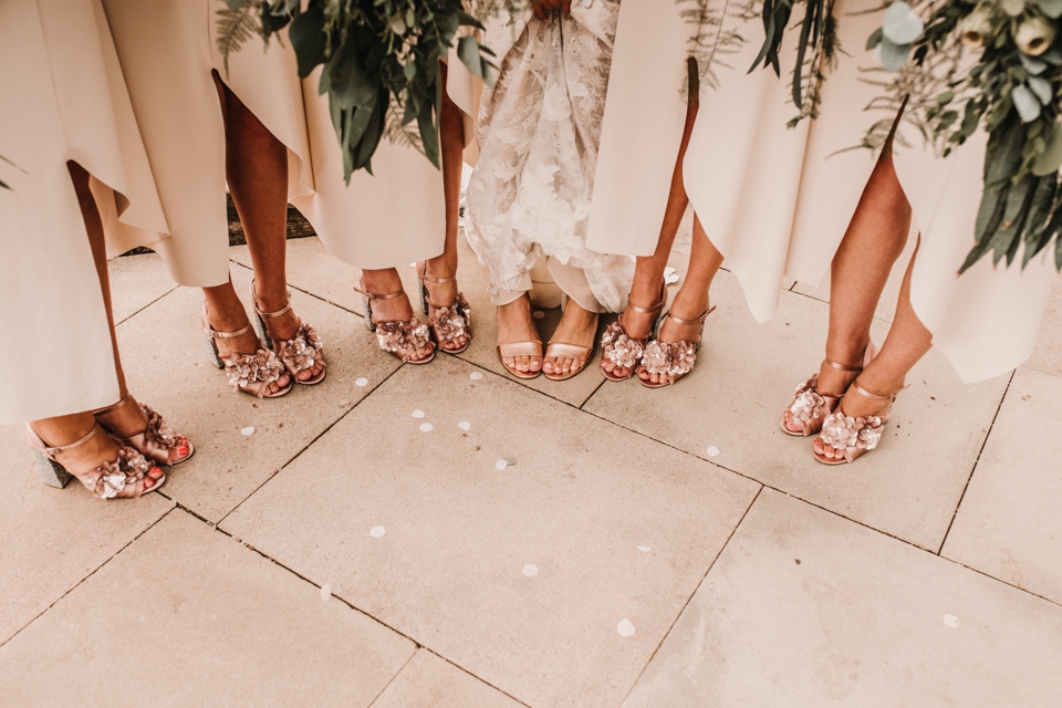 brides and bridesmaids chatting and close up of their beautiful shoes.