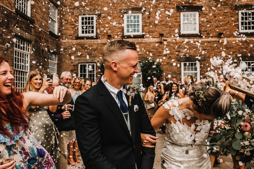 confetti photograph where bride is overwhelmed by the confetti