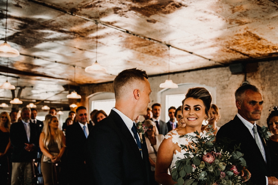 bride and grommet ceremony industrial wedding