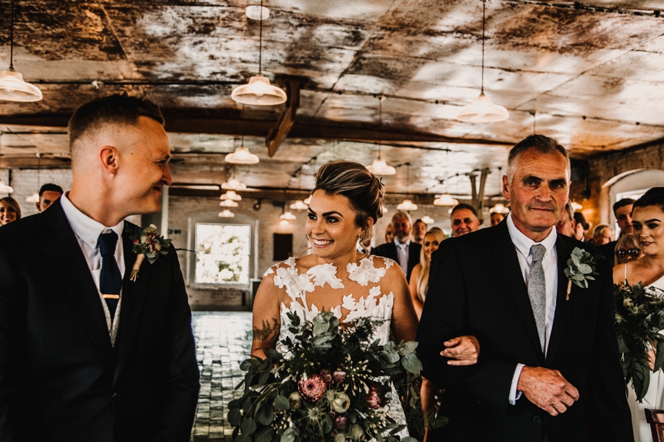 bride looking at her husband for first time at the start of the wedding ceremony