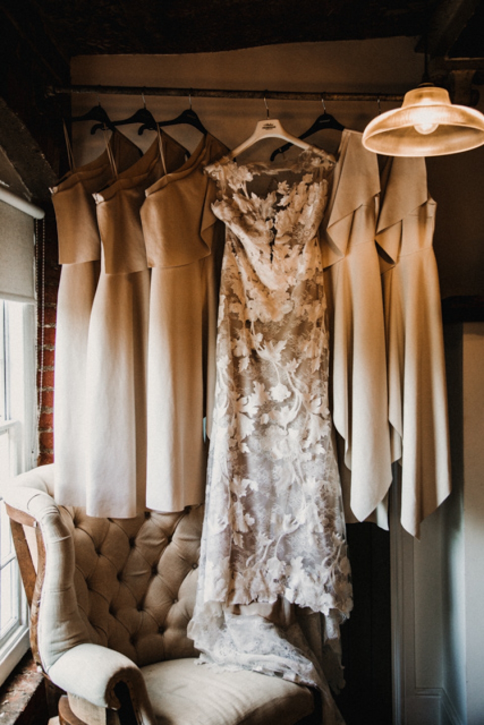 bride gown and bridesmaids hanging together